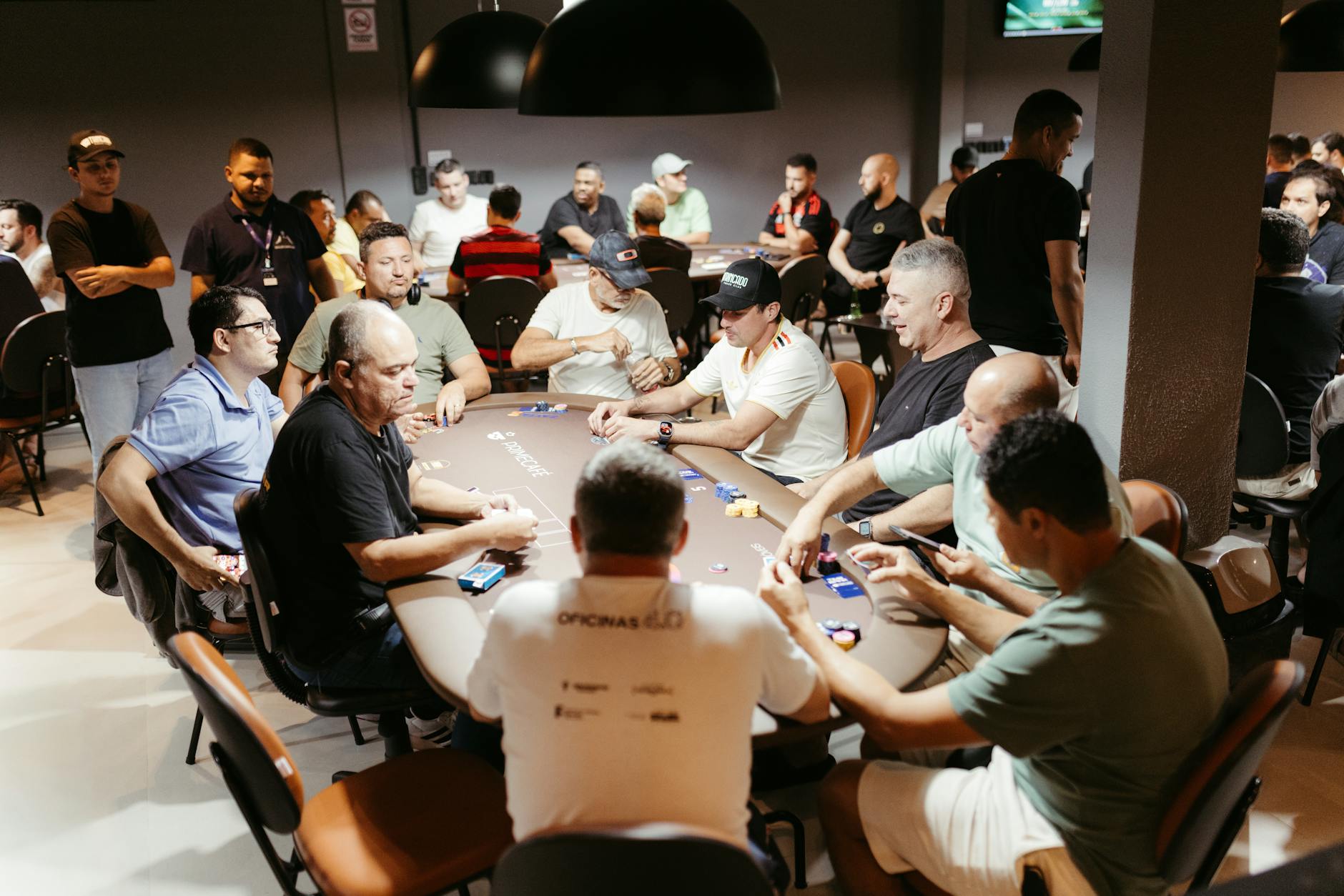 Vibrant scene of a poker tournament with players intensely focused, showcasing the dynamic atmosphere of casino gaming.
